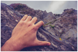 climbing on a rock with your hand