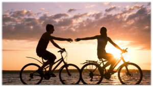 Two people riding along the shoreline in remote South Maui with the ocean and sunset at your side. 